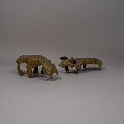 Par de esculturas a manera de piel de animal en latón martillado y repujado