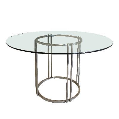 Mesa de comedor en acero cromado con cubierta circular de vidrio.
